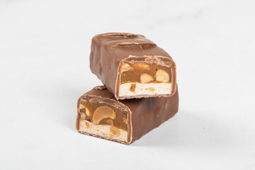 Mini Chocolate bar. Nougat, caramel with peanuts, in milk chocolate. White background
