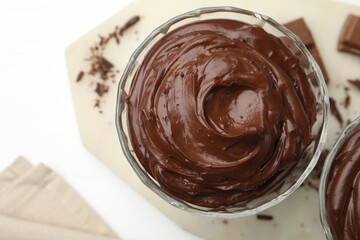 Delicious chocolate pudding on white table, flat lay