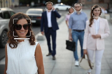 Facial recognition system identifying people on city street, selective focus