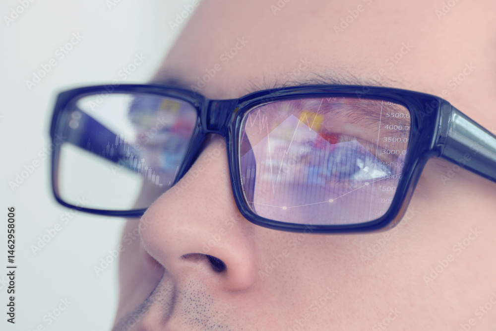 Poster stock exchange. trader analyzing data, closeup. graphs reflecting in his eyeglasses