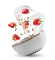 Oat flakes with fresh strawberries and milk splashing out from bowl in air on white background