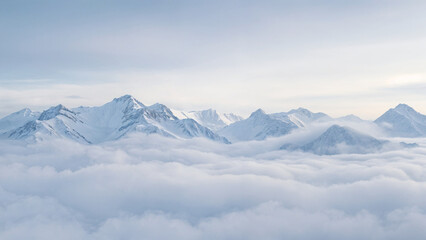 Majestic snow-covered mountain peaks rising above a sea of clouds. 