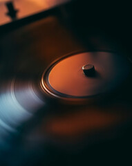 Close-up of a spinning vinyl record on a vintage turntable.

