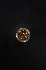 black and white peppercorns spice in a glass jar