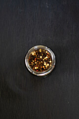 black and white peppercorns spice in a glass jar