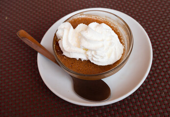 Sweet dessert coffee mousse whipped to delicate foam is served in small bowl for breakfast, decorated by whipped cream. Varied, healthy and delicious food, food bloggers