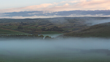 Early morning landscape fog mist blue hour hills new zealand otago