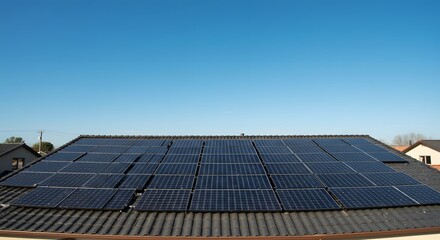 Solar panels on rooftop under a clear blue sky.