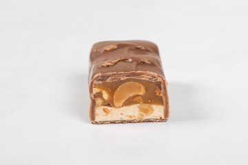 Chocolate bar. Nougat, caramel with peanuts, in milk chocolate. White background