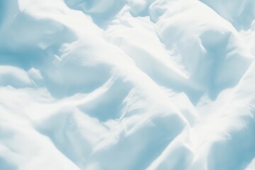 Light blue, soft, wrinkled fabric texture.  Wrinkled, light blue, white fabric folds in a soft, flowing pattern