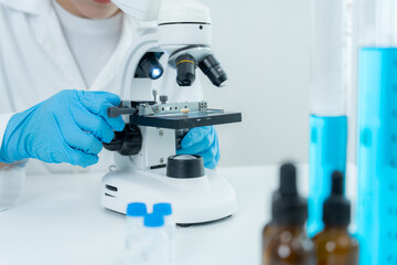 Scientist analyze biochemical samples in advanced scientific laboratory. Medical professional use...