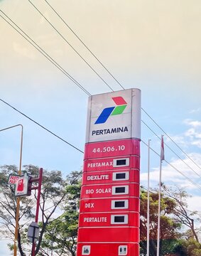 Semarang, Indonesia on 6 April 2025. Pertamina Gas Station Sign Under Blue Sky Displaying Fuel Prices Today