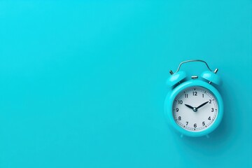 Light teal alarm clock on vibrant turquoise background