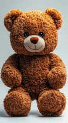 Fototapeta premium Cute brown teddy bear toy sitting upright, centered shot