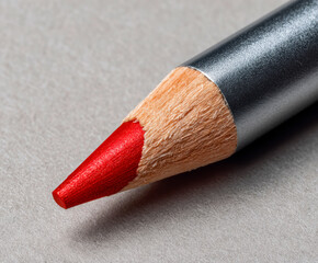 One beautiful lip pencil on light grey background, closeup. Space for text