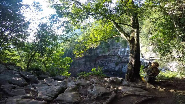 Tourist observing the sotano de las golondrinas in aquismon, mexico