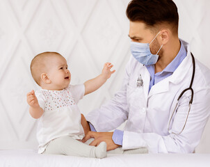 Medical Checkup. Male Doctor Pediatrician Examining Baby Toddler In Clinic. Sick Little Newborn...
