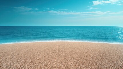 Fototapeta premium Calm seashore with gentle waves lapping against a pebble beach under a bright blue sky with light clouds