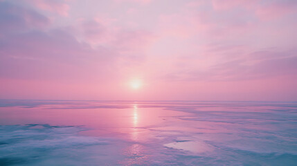Naklejka premium A beautiful pink and purple sky with a sun setting over the ocean