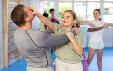 Self-defense training - girl delivers painful blow to the eyes of a male trainer