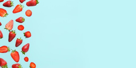Many flying strawberries on light blue background with space for text