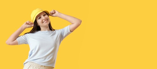 Happy young woman in bucket hat on yellow background with space for text © Pixel-Shot