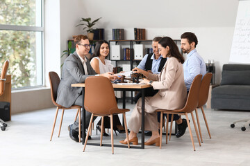 Group of lawyers working at table in office