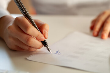 woman signing a real estate contract