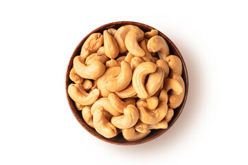 Top view of Roasted cashew nuts in wooden bowl isolated on white background.