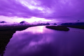 Fototapeta premium Aerial view landscape mountains colorful purple sky over sea