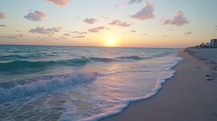 Golden sunrise over tranquil beach waves