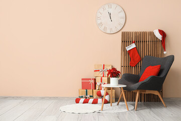 Interior of living room with armchair, folding screen and Christmas plant poinsettia on table