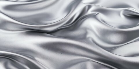 Fototapeta premium Silver satin fabric with smooth curves and folds, creating a luxurious and elegant texture, soft lighting, minimalist background