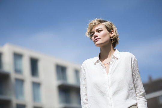sociologist portrait positioned on left side of frame hands out of view expressing analytical emotion