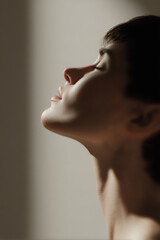 minimalistic mockup showcasing models face soft lighting highlighting features with blurred sunny background