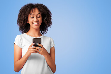 Romantic message, chat, good mood, social networks and best offer at sale from store. Happy young african american female typing on phone, isolated on violet background, free space, studio shot