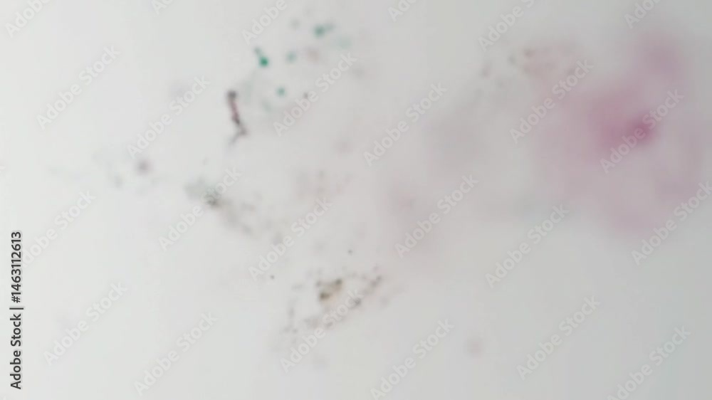 Poster abstract video of colorful particles floating and dispersing on a white background