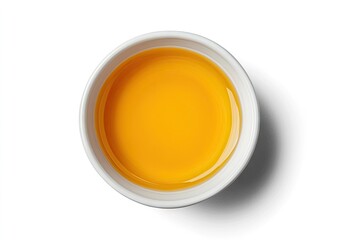 A pristine white bowl filled with vibrant yellow oil. placed on a clean surface. showcasing its glossy texture. ideal for culinary or food-related imagery