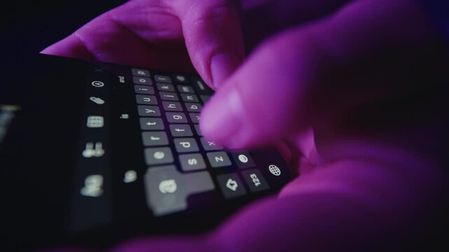 Fingers Typing In Note App Under Purple Light