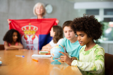 Fototapeta premium in geography lesson, elderly teacher very eloquently tells children about history of ancient Serbia
