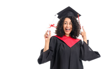 Happy African-American female graduate pointing at diploma on white background