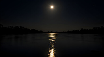 Obraz premium Moonlight Shimmers On Calm Water Surface During the Tranquil Night