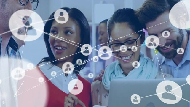 Team collaborating around laptop, displaying network connection icons for digital marketing
