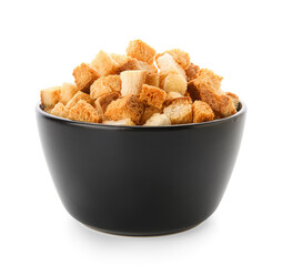 Black bowl with crunchy croutons on white background