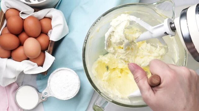 Baking a triple layer light blue cake with buttercream icing.  Decorating a vanilla cake for spring time.  Icing a cake and using coconut and candy eggs to make it look like a robin egg.