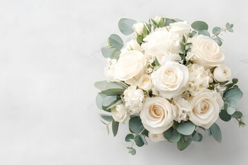 Elegant White Bridal Bouquet: A luxurious arrangement of creamy white roses, delicate carnations, and silvery eucalyptus leaves creates a timeless and elegant bridal bouquet.