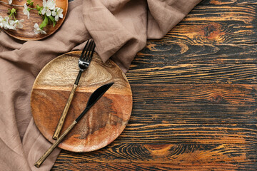 Beautiful table setting with blooming branch on wooden background