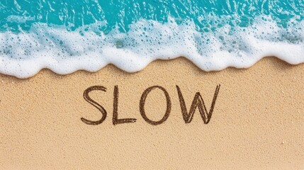 Fototapeta premium Tranquil Beach Scene with the Word Slow Written in the Sand Near Gentle Ocean Waves