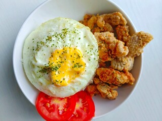 Fried Egg with Rice and Chicken Meal Served on Plate