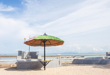 The beauty and comfort of the tropical beach of Lasiana Beach in Kupang City, East Nusa Tenggara, Indonesia. With umbrellas, coconut trees and sunny weather.